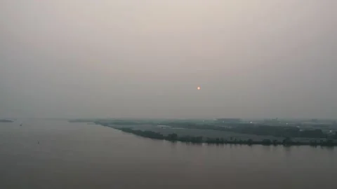 Aerial View Timelapse of the Sun Setting Obstructed by a Smoke Stock Footage 163780350