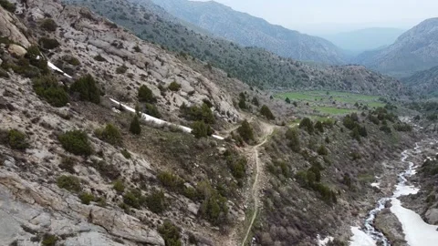 Aerial View of Tiny Hikers on Mountain Trail by Rushing River Stock Footage 332216802