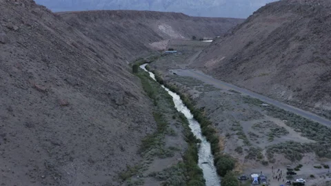 Aerial view of tiny river running down deep valley. Camping spot by the Stock Footage 153218731