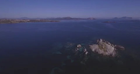 Aerial, a view on a tiny stone island in the middle of Mediterranean sea in S Vídeo Stock 100666346
