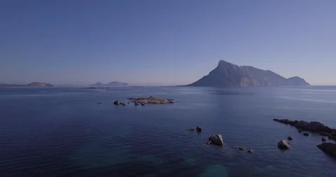 Aerial, a view on a tiny stone island in the middle of Mediterranean sea in S Vídeos de archivo 101377472