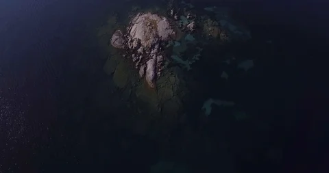 Aerial, a view on a tiny stone island in the middle of Mediterranean sea in S Stock-Footage 102890989