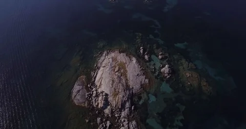 Aerial, a view on a tiny stone island in the middle of Mediterranean sea in S Stock-Footage 104245149