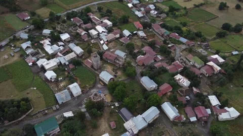 Aerial view of tiny village Mazeri in Caucasus Mountains of Georgia Stock Footage 295189837