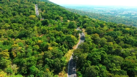 Aerial view from top to bottom of a white car driving on a mountain country road Stock Footage 166456992