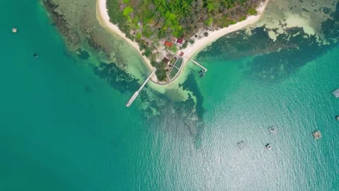 Aerial view from top of calm blue sea with green tropical island Stock Footage 287600548