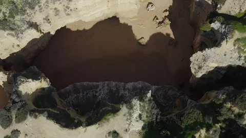 Aerial View From The Top Of A Cliff While The Waves Comes To Shore Stock Footage 128836788