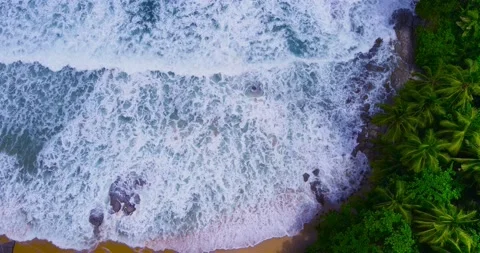 Aerial view Top-down Beach sand and seawater wave in sunset time. Stock Footage 233755359