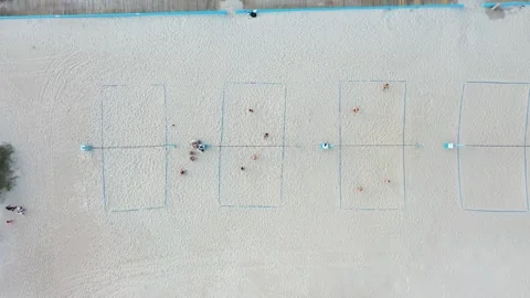 Aerial view top down of people on the beach playing volleyball in the sand Stock Footage 247992485