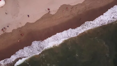 Aerial view top down of relaxing view of green ocean waves crashing onto Stock Footage 221234661