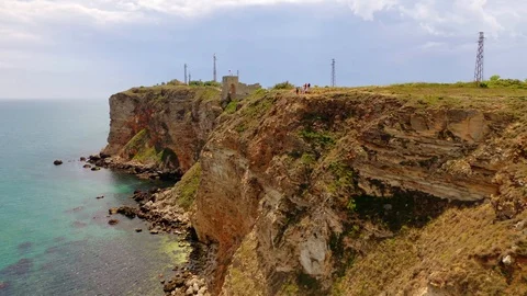 Aerial view of top down view of the red rocky coastline Stock Footage 109249482