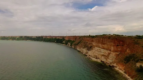 Aerial view of top down view of the red rocky coastline Stock Footage 109249573
