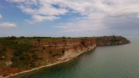 Aerial view of top down view of the red rocky coastline Stock Footage 109249575