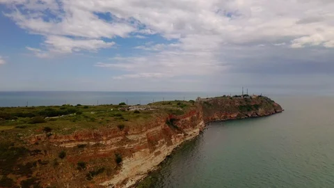 Aerial view of top down view of the red rocky coastline Stock Footage 109249621