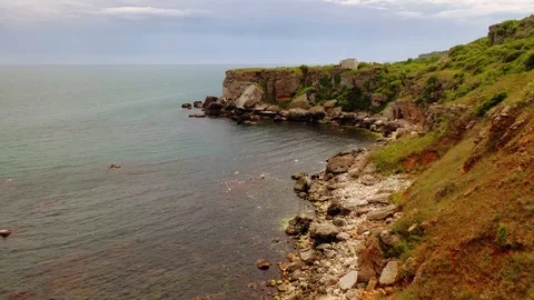 Aerial view of top down view of the red rocky coastline Stock Footage 109249644