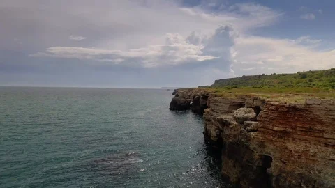 Aerial view of top down view of the red rocky coastline Stock Footage 109249726