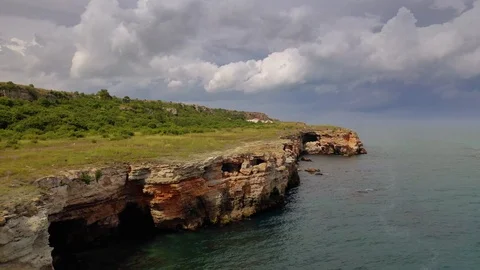 Aerial view of top down view of the red rocky coastline Stock Footage 109249728