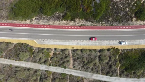Aerial view top down view of of a straight road and rugged coastline at Guincho Stock Footage 164608337