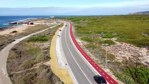 Aerial view top down view of of a straight road and rugged coastline at Guincho Stock Footage 164609024