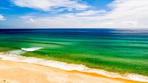 Aerial view Top down Waves crashing on sandy shore,Dark sea surface in summ.. Stock Photos