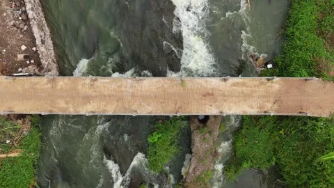 Aerial view from top of river flow under small bridge Stock Footage 292586144