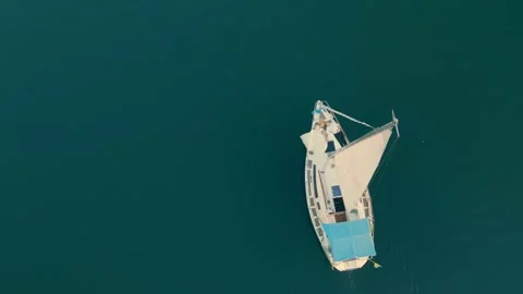 Aerial view on top Two young people are lying on a yacht and pouring in the open Stock Footage 151226548