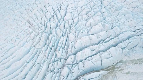 Aerial view: Top View Glacier Ice Flow Texture Vibrant Blue. Climate Change Stock Footage