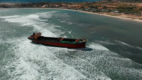 Aerial view, top view of old rusty stranded logistics ship on the beach Stock Footage 296483488