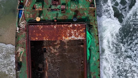 Aerial view, top view of old rusty stranded logistics ship on the beach Stock Footage 296483638