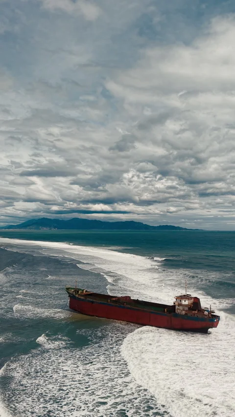 Aerial view, top view of old rusty stranded logistics ship on the beach Stock Footage 296483658