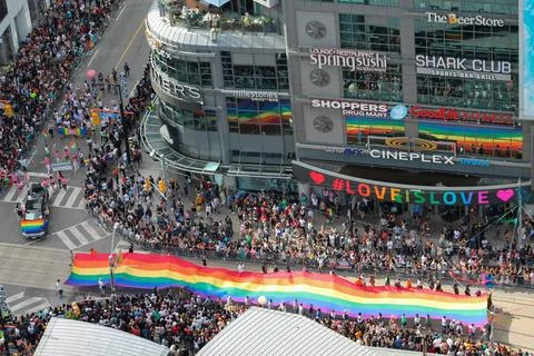Aerial view of Toronto Pride Parade showing a massive rainbow flag carried .. Stock Photos