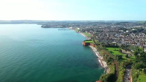 Aerial view of Torquay with train going along the coastline on a sunny day Stock Footage 165348400