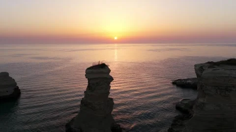 Aerial view of Torre Sant'Andrea stack rock at sunrise Stock Footage 346091209