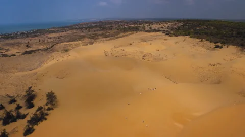 Aerial view of tourists exploring mui ne sand dunes in vietnam Stock Footage 329486261