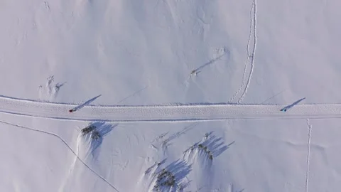 Aerial view of tourists exploring snowbound paths on fatbikes in Austria Stock Footage 313366428