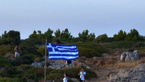 Aerial view of tourists at a viewpoint next to a Greece flag, sunset in Rhodes Stock Footage 314307207