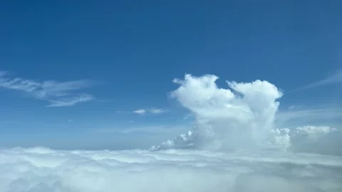 Aerial view toward a tiny cumulus top taken from a jet cockpit at 10000m Stock Footage 218371818
