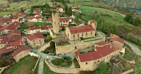 Aerial view of the tower and the stone church  of the Chambles Stock Footage 268645874