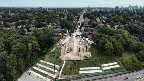 Aerial View of Tower Crane Building New Transit Bridge Pier Over Highway Stock-Footage 345835200