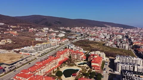 Aerial view of tower crane over coastal building site Video stock 338220668