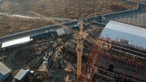 Aerial view of a tower crane working on an industrial construction site Stock Footage 121658633