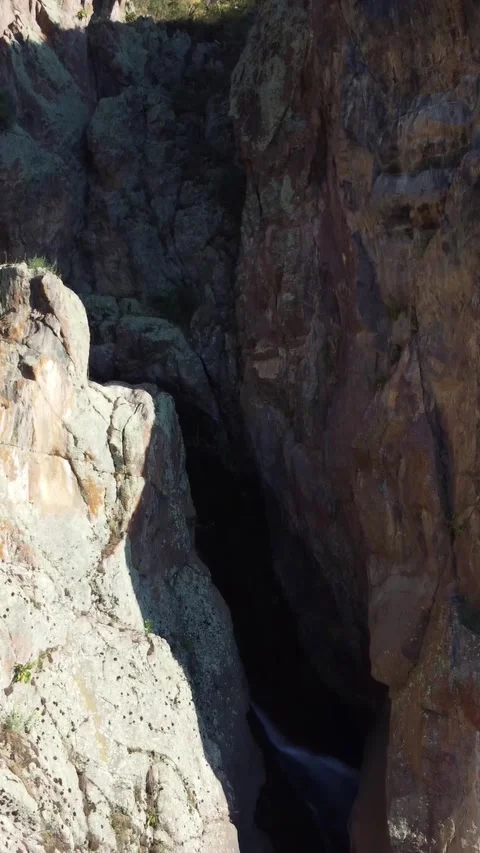 Aerial view of towering basalt walls and narrow tectonic abyss in Kazakhstan Stock Footage 338123400