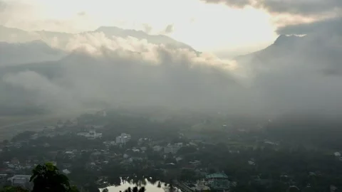 Aerial view of the town in clouds and mist in morning of the Mae Hong son Stock Footage 130424353
