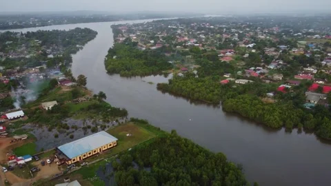 Aerial view of a town with a river running through it on a cloudy day Stock Footage 318520116