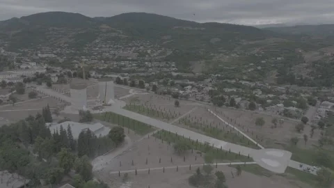 Aerial view of a town under construction, mountains and cloudy skies Stock Footage 341883729