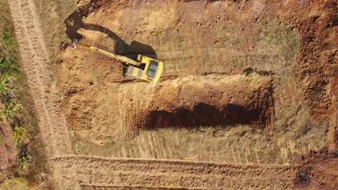 Aerial view, A trackhoe is digging the pond. Stock Footage 236928793