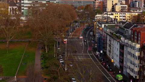 Aerial view tracking an ambulance driving in a German city boulevard, with Video stock 324105350