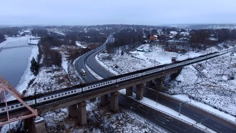 Aerial view tracking from a drone behind a railway train moving on a bridge Video stock 122427419