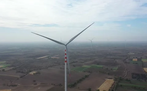 Aerial View Tracking Tall Wind Turbine Tower and Rotating Blades Over Dry Vídeo Stock 342489181