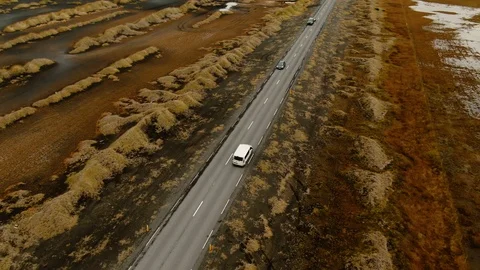 Aerial view tracking a van by a mossy beach with dunes in West Iceland Stock Footage 116546145
